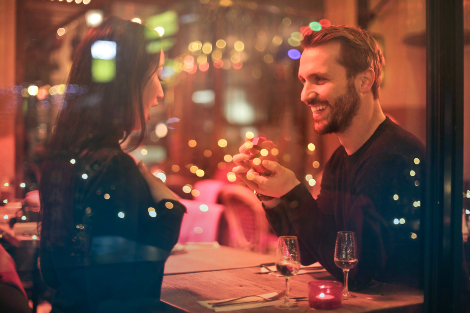 A couple laughing over dinner