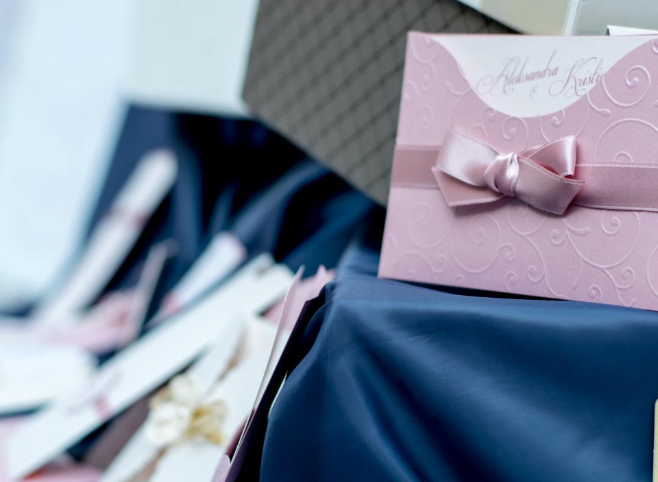 A wedding invitation tied with a ribbon